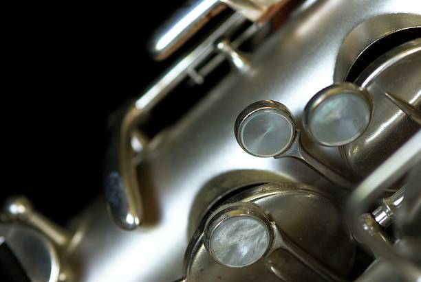 Close-up of Saxophone Keys and Pads on Black Background stock photo