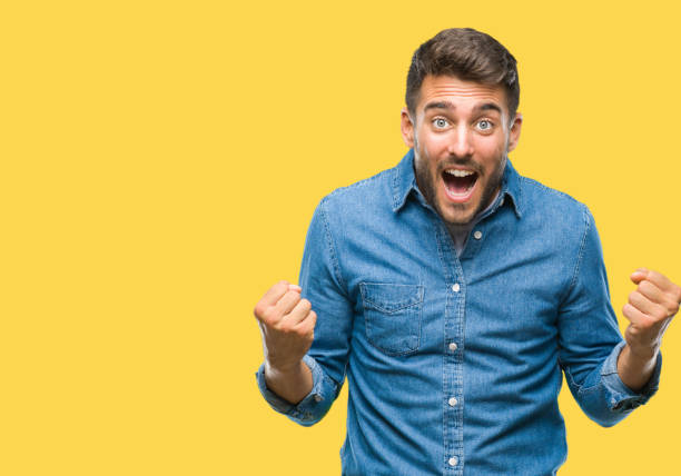 istock Young handsome man over isolated background celebrating surprised and amazed for success with arms raised and open eyes. Winner concept. 1081513242