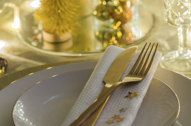 istock Christmas table setting with white plates and gold cutlery. Elegant festive dinner background with copy space. Xmas tableware background. 1081513392