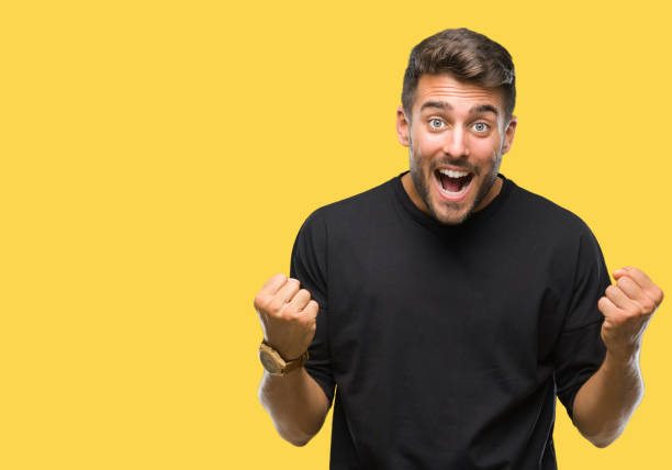 istock Young handsome man over isolated background celebrating surprised and amazed for success with arms raised and open eyes. Winner concept. 1081514922