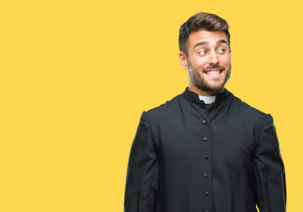 istock Young catholic christian priest man over isolated background smiling looking side and staring away thinking. 1081515618