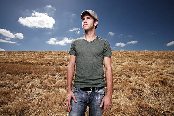Young man standing in field stock photo