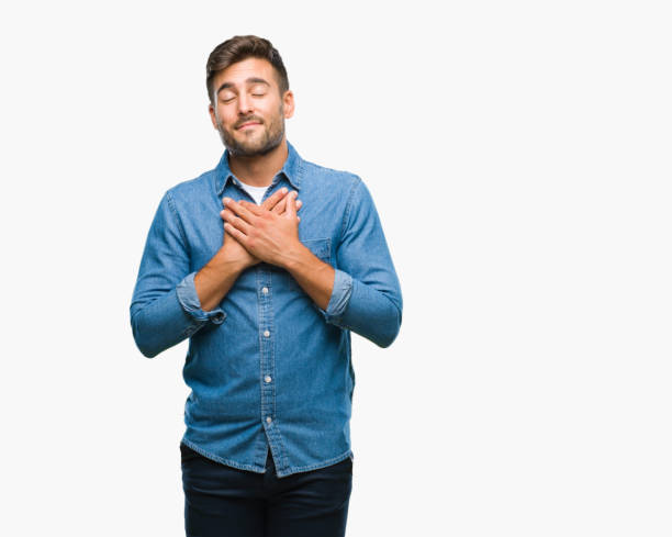 istock Young handsome man over isolated background smiling with hands on chest with closed eyes and grateful gesture on face. Health concept. 1081515970