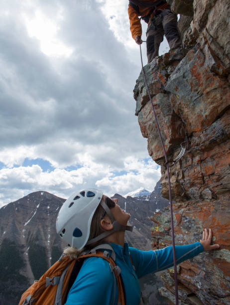 istock Climber gives a helping hand to other climber 1081516200