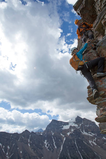istock Climber gives a helping hand to other climber 1081516398