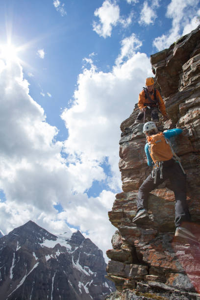 istock Climber gives a helping hand to other climber 1081516452