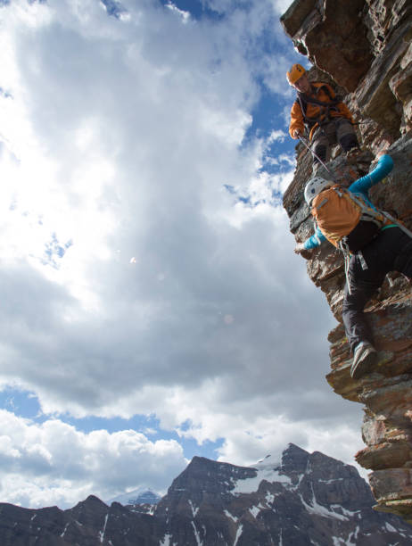 istock Climber gives a helping hand to other climber 1081516458