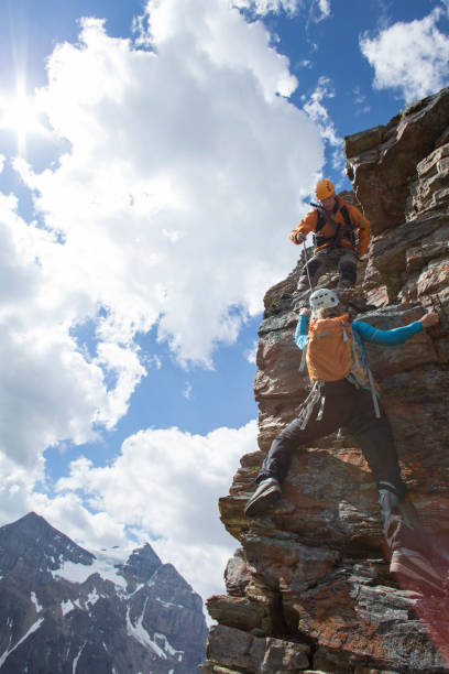 istock Climber gives a helping hand to other climber 1081516984