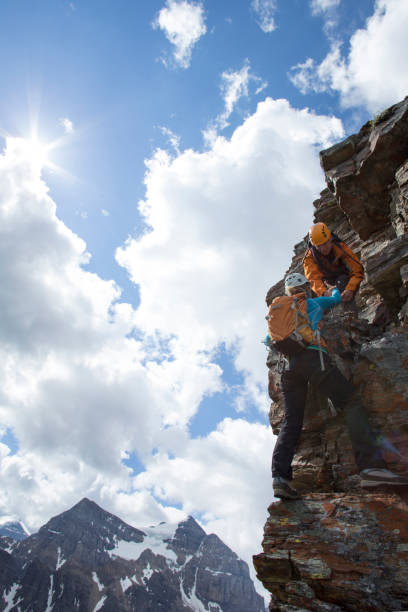 istock Climber gives a helping hand to other climber 1081517012