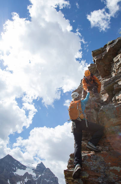 istock Climber gives a helping hand to other climber 1081517020