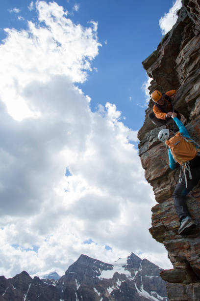 istock Climber gives a helping hand to other climber 1081517088