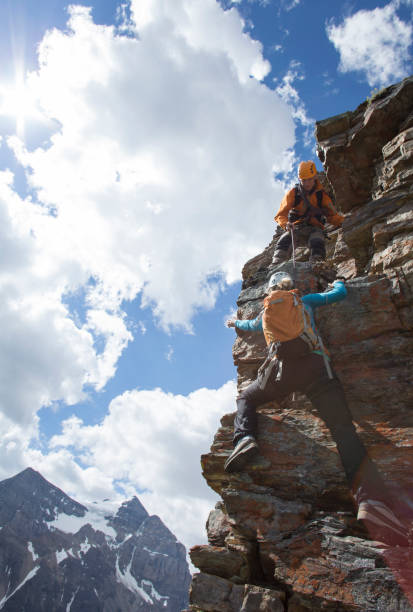 istock Climber gives a helping hand to other climber 1081517118
