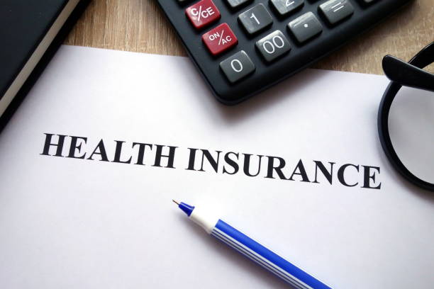 istock Health insurance document, calculator, pen and glasses 1081517350