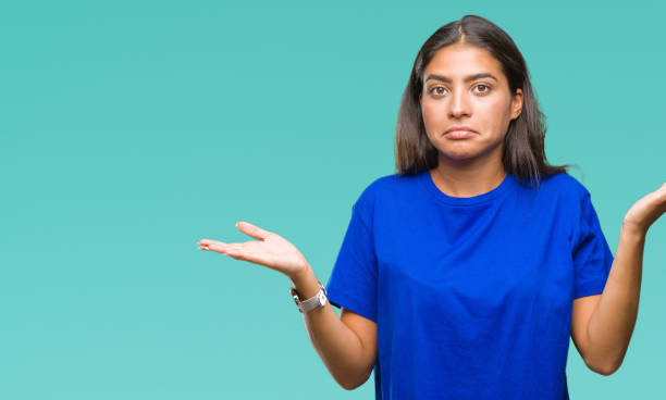 istock Young beautiful arab woman over isolated background clueless and confused expression with arms and hands raised. Doubt concept. 1081519496