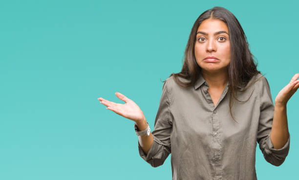 Young beautiful arab woman over isolated background clueless and confused expression with arms and hands raised. Doubt concept. Young beautiful arab woman over isolated background clueless and confused expression with arms and hands raised. Doubt concept. Dont stock pictures, royalty-free photos & images