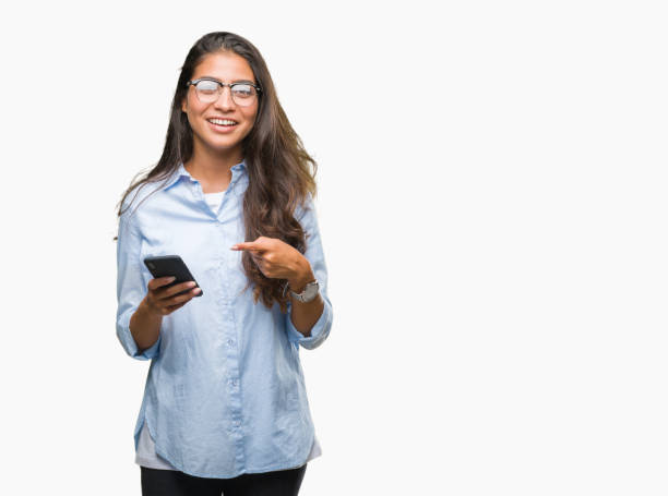 istock Young beautiful arab woman texting using smartphone over isolated background very happy pointing with hand and finger 1081521170