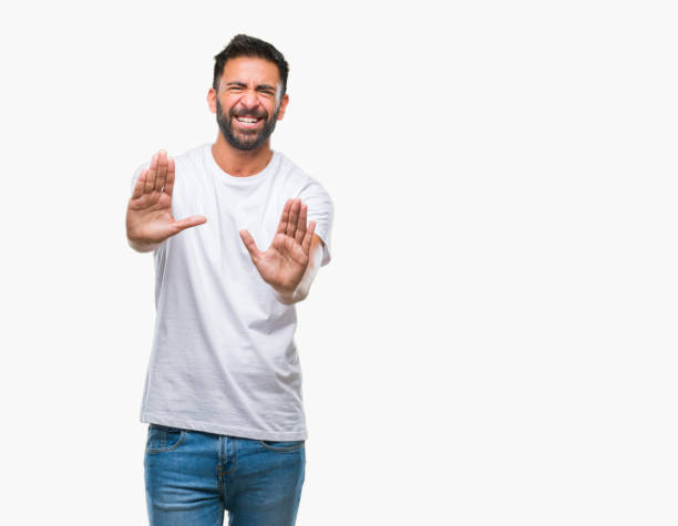 istock Adult hispanic man over isolated background afraid and terrified with fear expression stop gesture with hands, shouting in shock. Panic concept. 1081522458