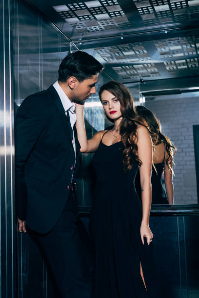 istock beautiful woman looking at camera man and touching man face in elevator 1081530088