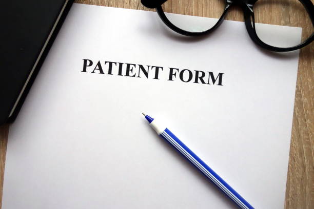 istock Patient form, pen and glasses 1081533102