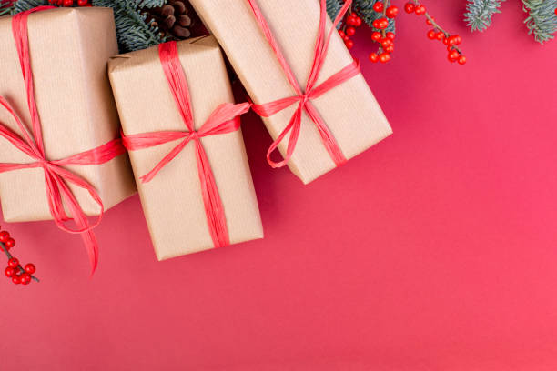 istock Christmas composition. Christmas red decorations, fir tree branches with toys gift boxes on red background. Flat lay, top view, copy space 1081533174
