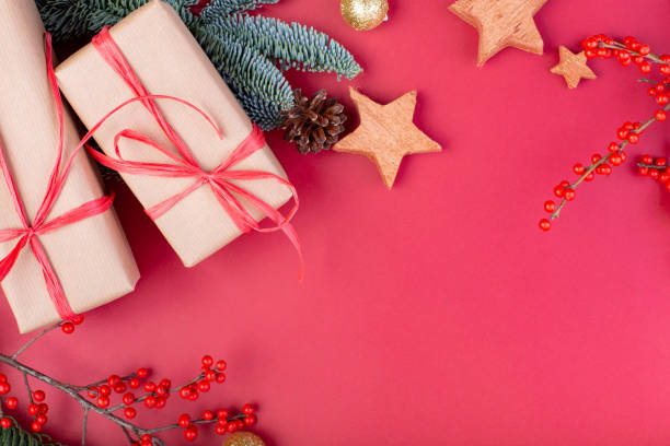 istock Christmas composition. Christmas red decorations, fir tree branches with toys gift boxes on red background. Flat lay, top view, copy space 1081533208