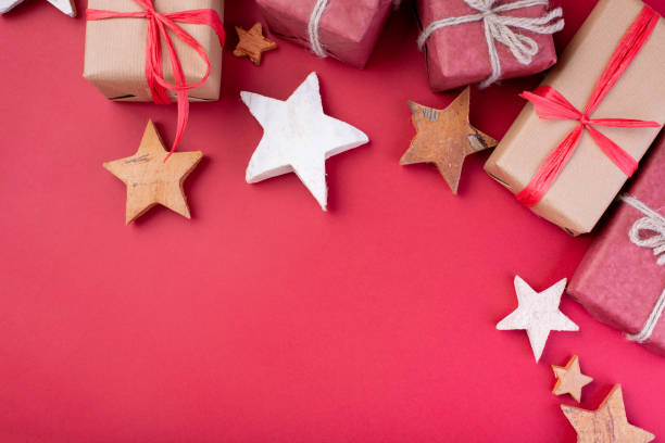 istock Christmas composition, greeting card. Christmas red decorations, stars and gift boxes on red background. Flat lay, top view, space for the text 1081533290