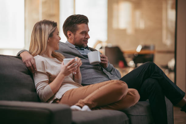 istock Happy couple on sofa drinking coffee 1081534690