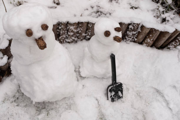 istock Two snowmen with a nose cone, standing in the snow 1081535180
