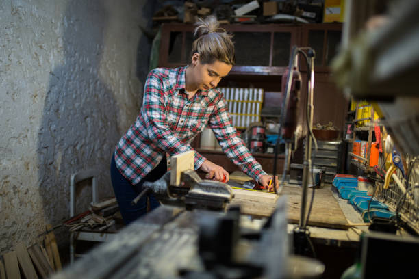 istock Female carpenter measures wood 1081536134