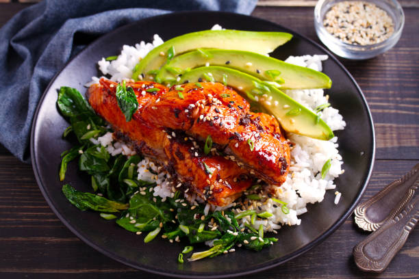 istock Salmon in honey-soy glaze with rice, spinach and avocado 1081537974