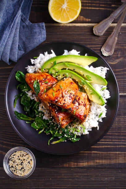 istock Salmon in honey-soy glaze with rice, spinach and avocado 1081538730