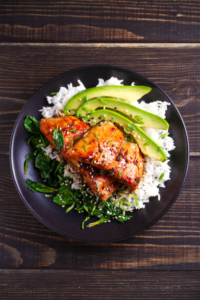 istock Salmon in honey-soy glaze with rice, spinach and avocado 1081538982