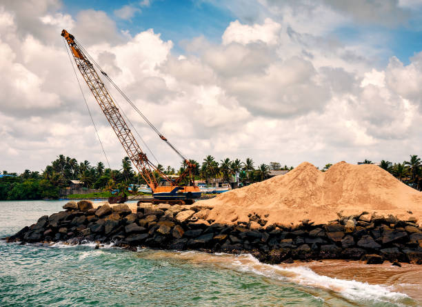 istock the crane takes sand from the ocean 1081539836