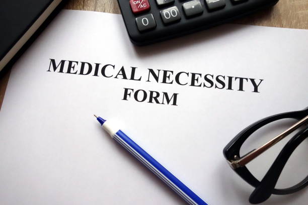 istock Medical necessity form, pen and glasses 1081548532