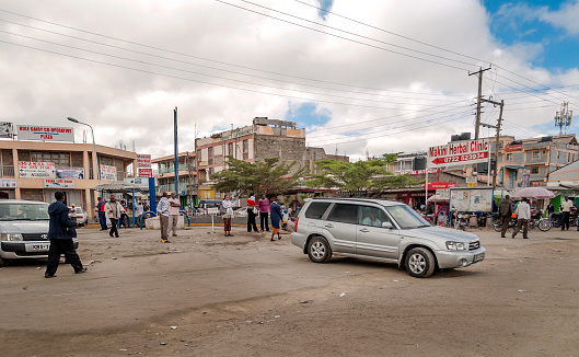 NAIROBI, KENYA - MAY 2014.Street scene in Nairobi. Cars and people in street. In background there are buildings, shops and advertising billboards. Nairobi is the capital and largest city of Kenya. The name Nairobi comes from the Masái phrase Enkare Nyorobi, which means \