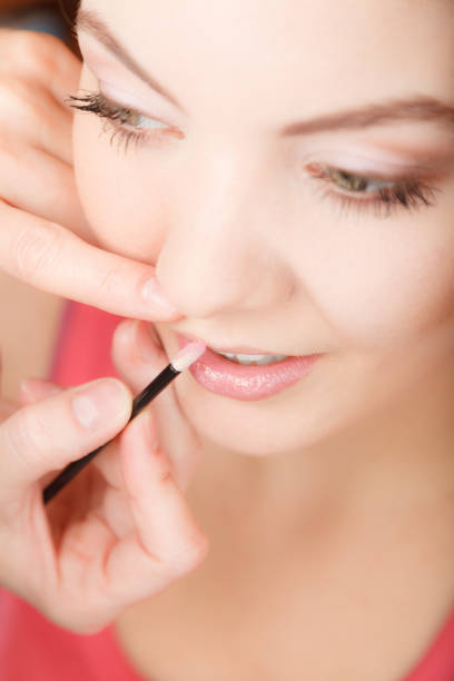 istock Attractive woman applying lipstick. Make up. 1081555020