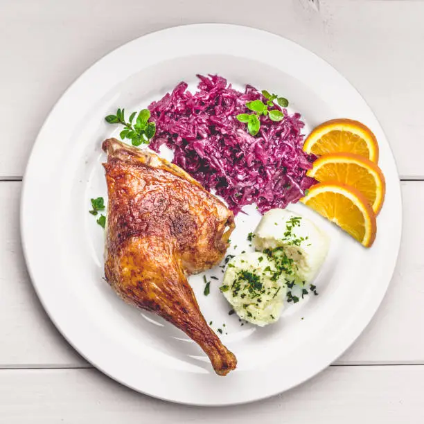 Roast duck with dumplings, red cabbage and oranges