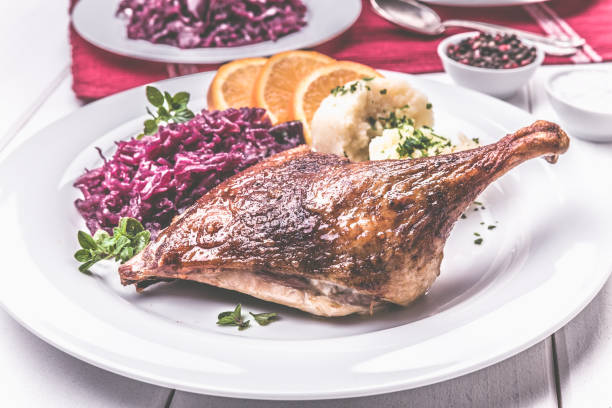 istock Roast duck with dumplings, red cabbage and oranges 1081556070