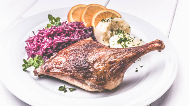 istock Roast duck with dumplings, red cabbage and oranges 1081556180