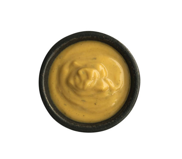 istock Mustard Sauce in Round Black Bowl Isolated on White Background 1081557906