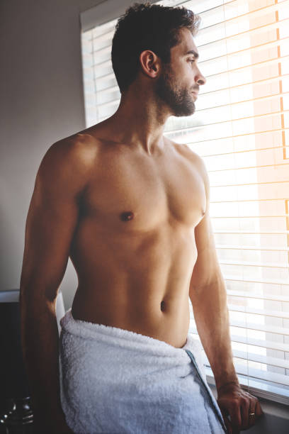 It's gonna be a beautiful day Cropped shot of a handsome young man standing in a in his bedroom towel at home chest torso photos stock pictures, royalty-free photos & images