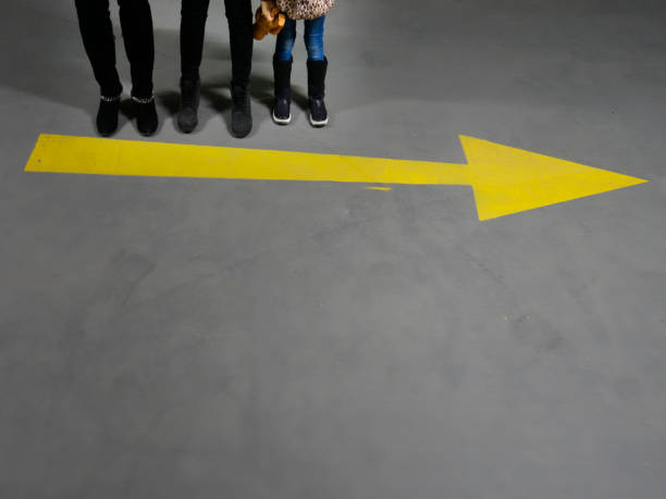 istock Multiple foot feet standing with the leading arrow - 1081566754