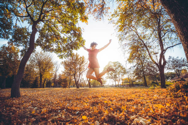 istock Jump of joy in a park 1081572348