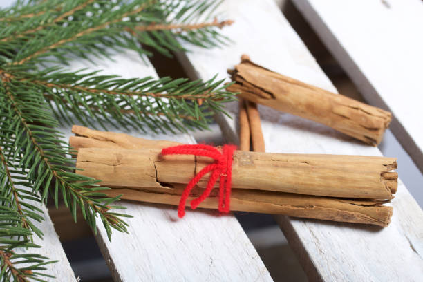 istock Cinnamon sticks next to the fir branches. On a wooden box. 1081579084