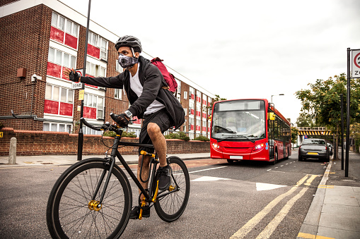 Cyclist commuter wearing a pollution-mask in Central London