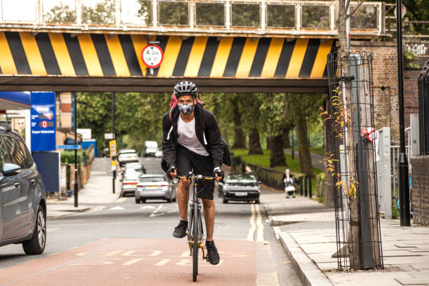 istock Cyclist commuter wearing a pollution-mask in Central London 1081582458