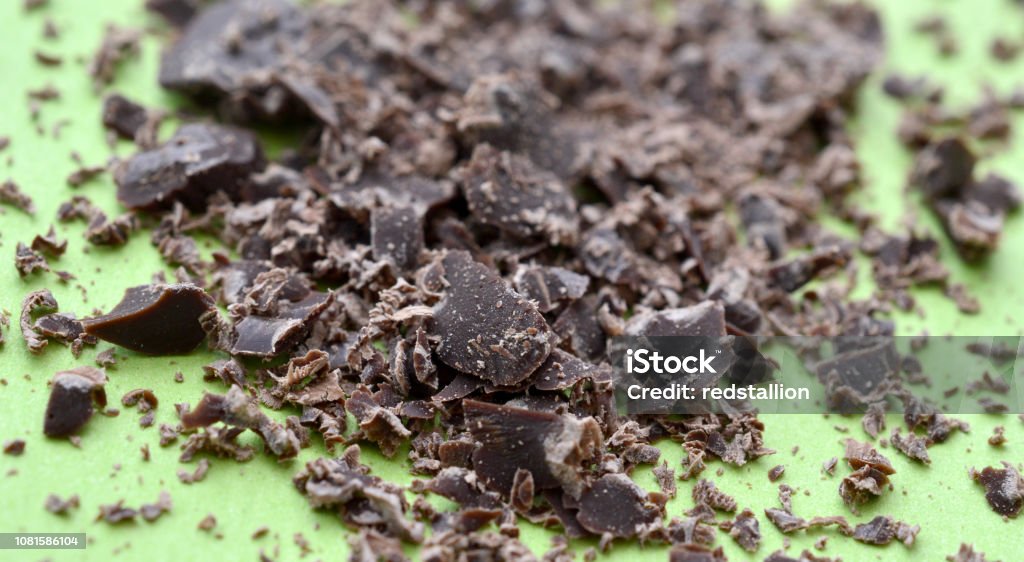 dark chocolate crumbs on green background dark chocolate crumbs on green background,image of a Black Color Stock Photo