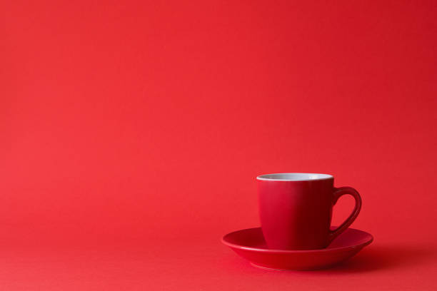 istock Red cups of tea or coffee on red paper background. Copy space 1081588590