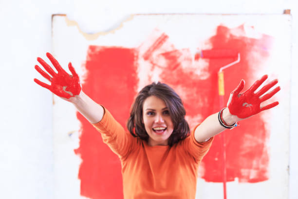 istock Cheerful woman with hands painted in red 1081594136