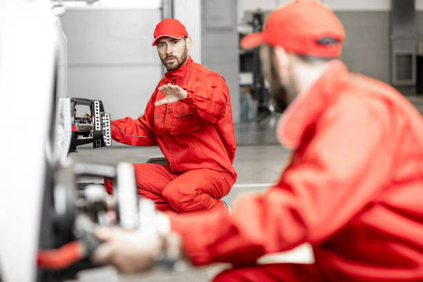 istock Auto mechanics making wheel alignment at the car service 1081594252